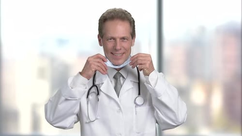 Doctor Puts on Surgical Mask in Hospital Setting