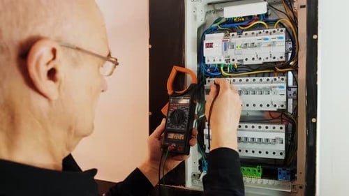 Electrician Testing Voltage on Home Electrical Panel