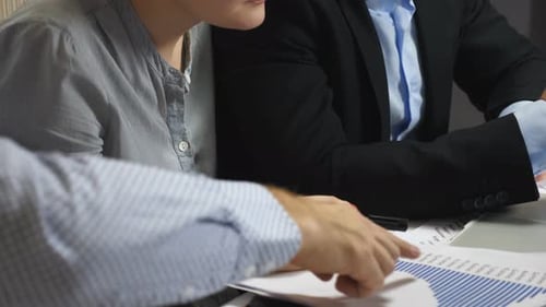 Professional Managers Analyzing Charts with Sales Result During Team Meeting in Office