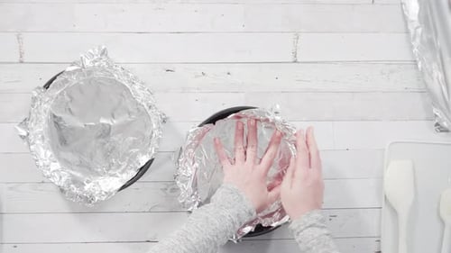 Flat lay. Step by step. Lining the baking pan with cooking foil to make homemade fudge.