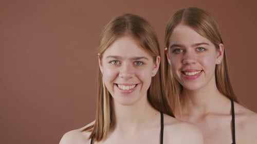 Laughing Twin Girls Posing for Camera
