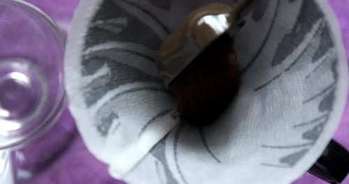 Coffee Grounds being Poured into Coffee Filter