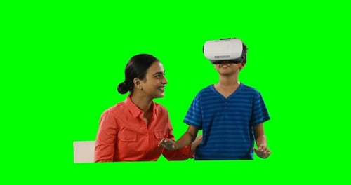 Smiling mother assisting son in using virtual reality headset 4k