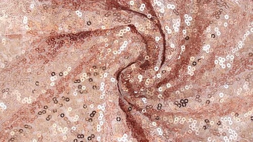 Tissu rose doré à paillettes
