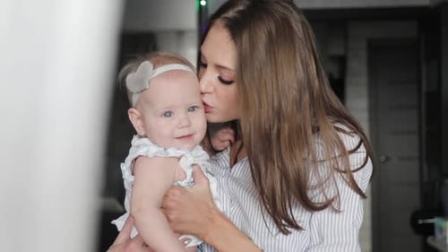 Happy Mother and Baby Kissing and Hugging