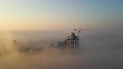 Aerial View of Cement Factory with High Concrete Plant Structure and Tower Crane at Industrial
