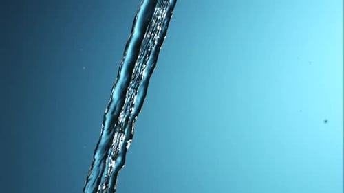 Stream of Pouring Water Breaks Into Droplets