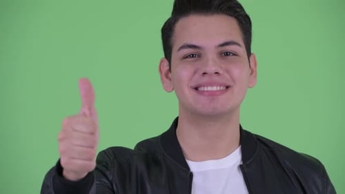 Smiling Young Adult Gives Thumbs Up Approval