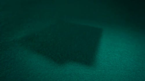 Ace Playing Cards Falling onto Green Table