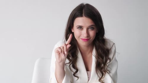Woman raising finger to make a point