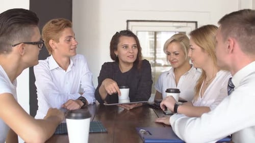 Happy Creative Team Drinking Coffee at Break and Having Discussion in Office