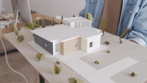 Architect Holding House Layout