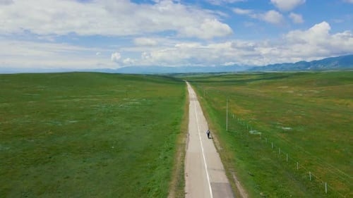 Man Ride Bicycle on the Mountain Road Top View