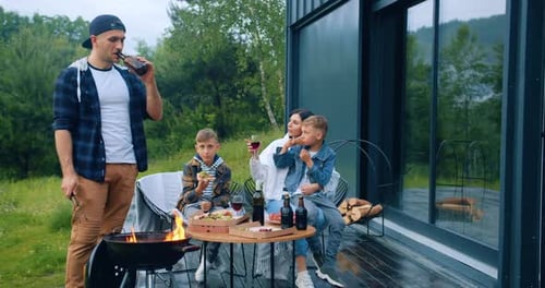 Family Enjoys Pizza at Outdoor Grill Gathering