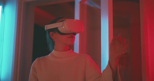Woman Using VR Headset with Neon Lighting