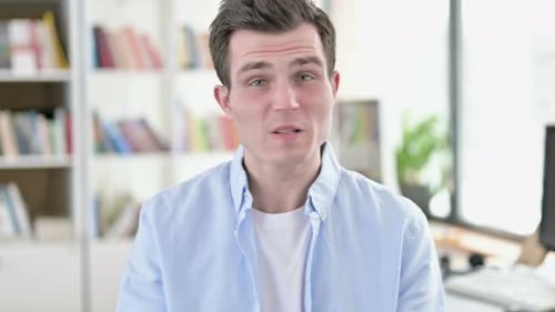 Young Adult Man Disappointed on Video Call