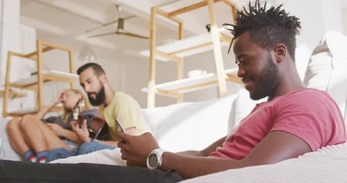 Friends Relaxing on Sofa at Home