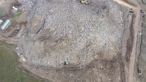 Flying Over a Large Landfill Near a City