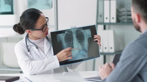 Doctor Explains X-Ray Results to Patient