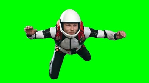 Skydiver in White Helmet Floating Against Green Screen