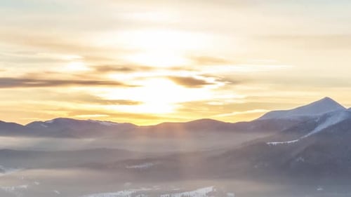 Foggy Morning in the Winter Mountains Forest on the Background of Dramatic Cloudy Sky. Timelapse.