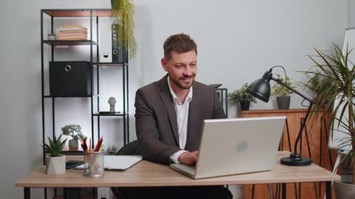 Businessman Freelancer Enters Office Workplace Working on Laptop Computer Sends Online Messages