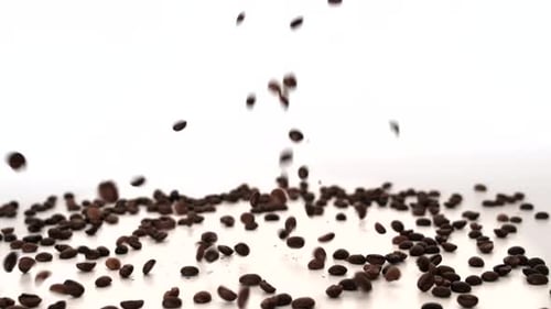 Roasted Coffee Beans Falling onto White Surface