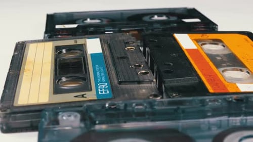 Four Audio Cassettes Rotate on White Background