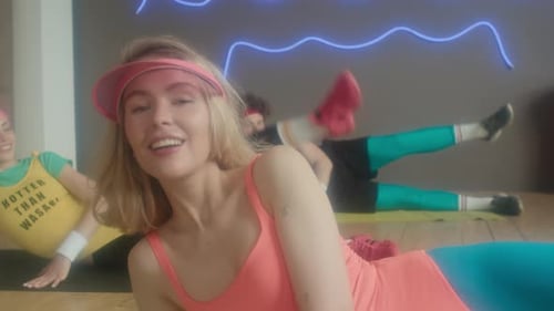 People in Exercise Class Performing Leg Lifts