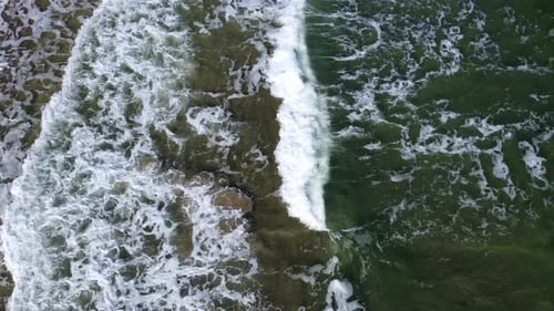 Aerial Drone View Flight Over Sea Waves That Roll Onto Sandy Shore