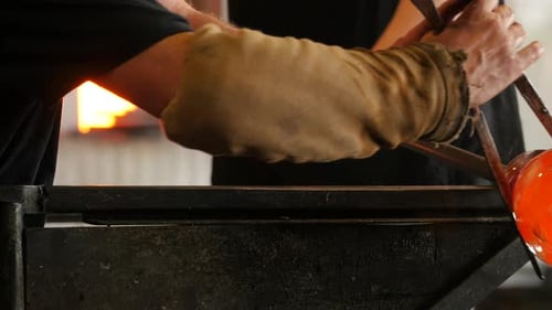 Skilled Glassblowers Shape Molten Glass in Workshop