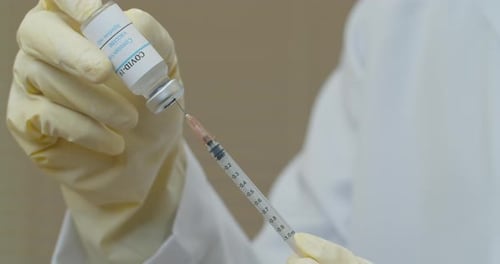 Filling COVID-19 Vaccine Syringe in Hospital Setting