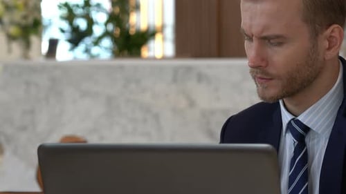 MS of businessman happiness at desk with laptop in lobby space office background