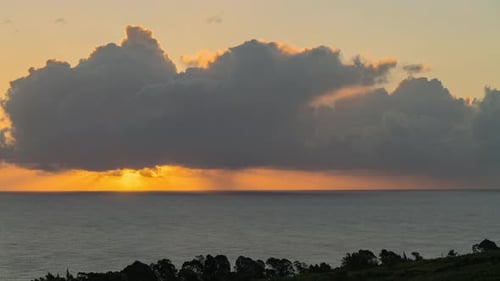 Golden Sunrise Over the Ocean With Dramatic Clouds