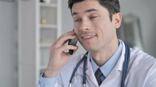 Male Doctor Talking on Cell Phone Close Up