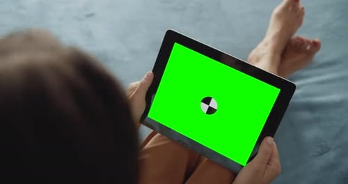 Woman Uses Tablet with Green Screen at Home