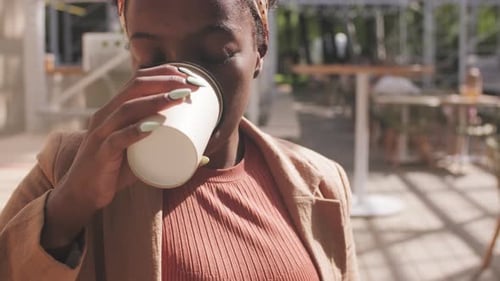 Woman with Tablet Enjoying Coffee in Cafe Patio