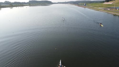 Aerial view of professional sportsmen rowers sailing along the rowing canal in kayaks.