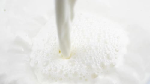 Pouring fresh milk in slow motion