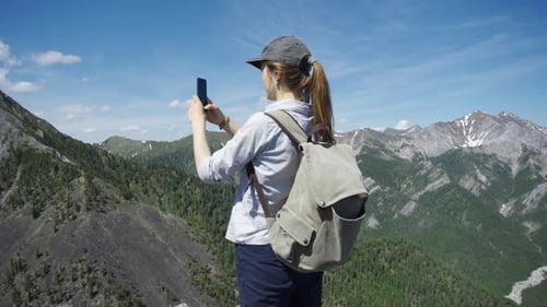 Woman Takes Mountain Photo With Her Mobile Phone