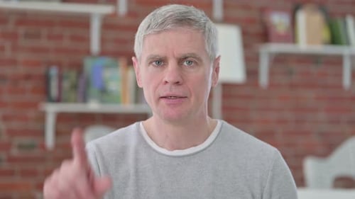 Senior Old Man Saying No with Finger Gesture