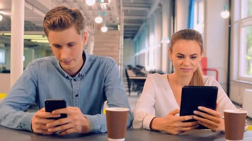 Young Adults Using Technology in Modern Office