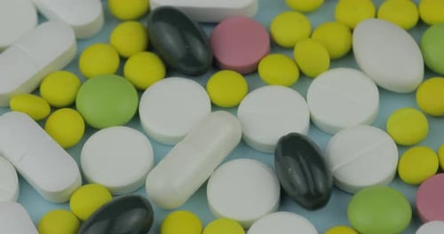 Colorful Pills and Capsules on Blue Background