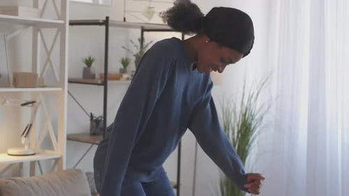 Happy Woman Dancing at Home with Enthusiasm