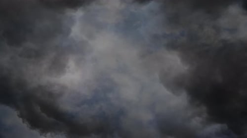 the stroms behind the white clouds