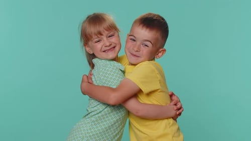 Happy Children Embracing in a Studio Setting