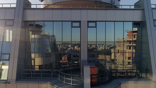 Aerial view of modern skyscraper with glass facade at evening 17
