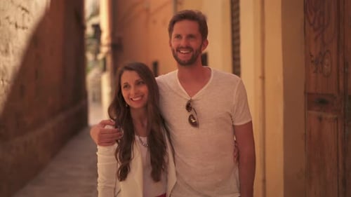 Affectionate Couple Walking Together in a Picturesque Alleyway