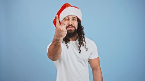 Excited Man Celebrates in Santa Hat with Confetti