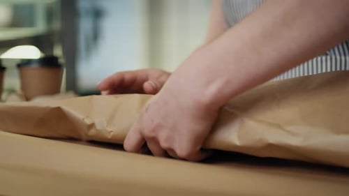 Sandwich Being Wrapped at a Restaurant